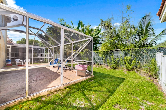 view of yard with a patio and glass enclosure