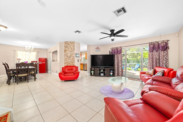 tiled living room featuring ceiling fan with notable chandelier