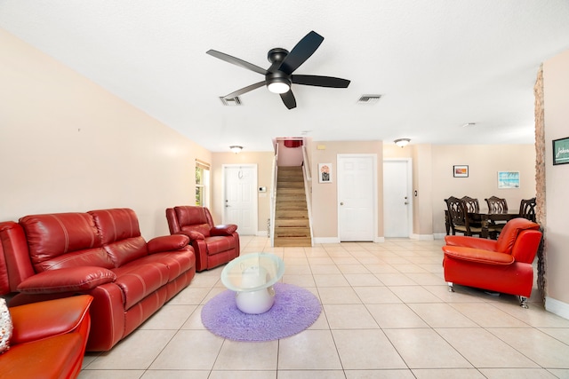 tiled living room featuring ceiling fan