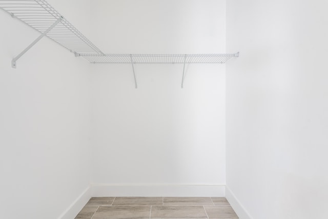 spacious closet featuring wood finish floors