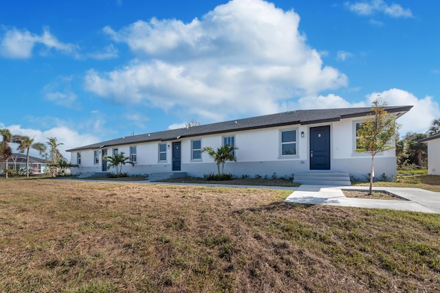 ranch-style home with stucco siding and a front lawn