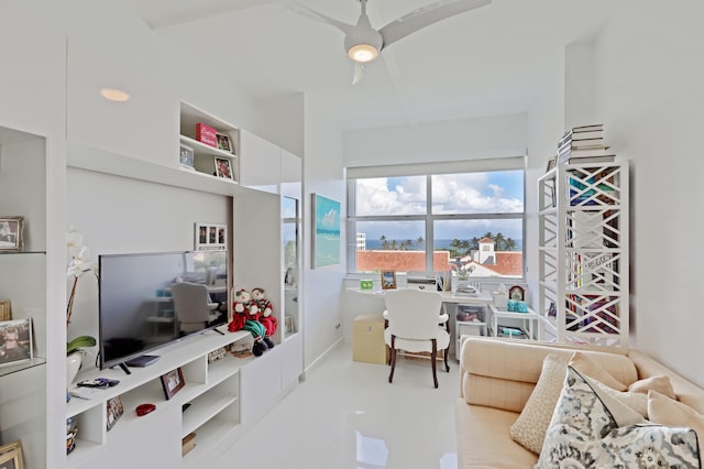 interior space with ceiling fan