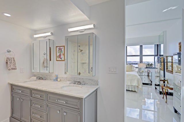 bathroom featuring a shower and double vanity