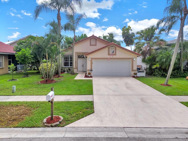 view of front of property with a garage and a front lawn