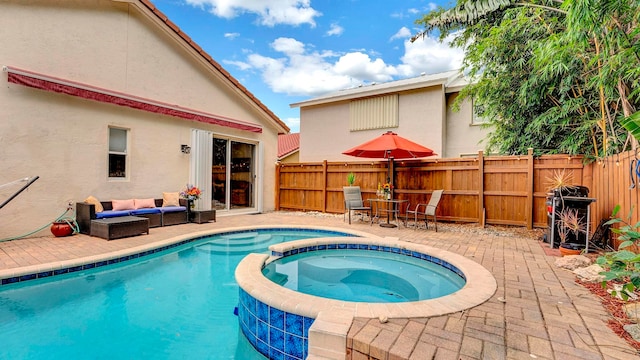 view of swimming pool with an in ground hot tub, an outdoor living space, and a patio