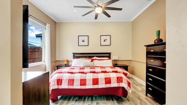 bedroom with ceiling fan, light wood-type flooring, and crown molding