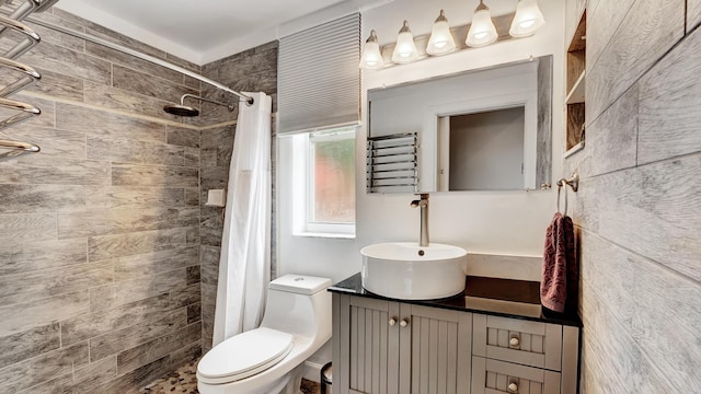 bathroom featuring toilet, a shower with curtain, vanity, and radiator