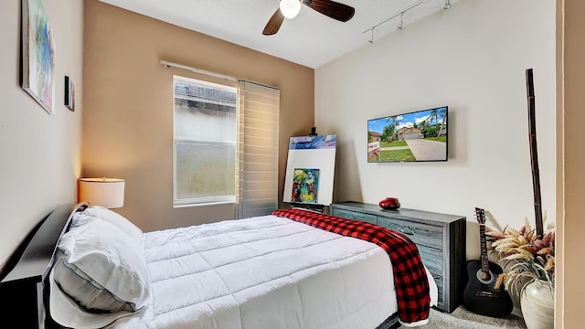 bedroom featuring ceiling fan and rail lighting