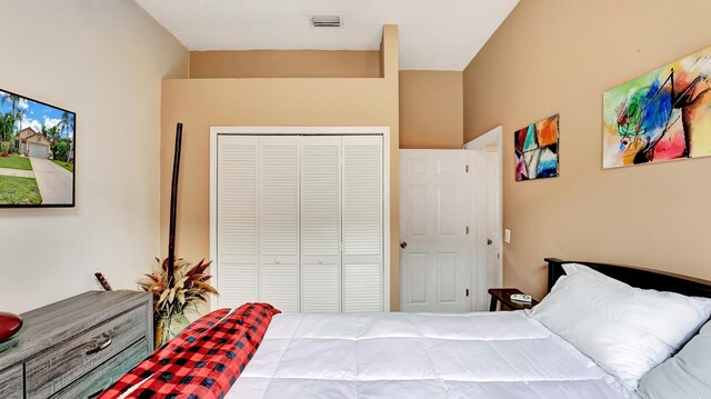 bedroom with a closet and a towering ceiling