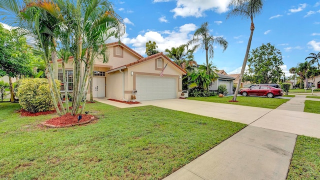 view of front of home featuring a front yard and a garage