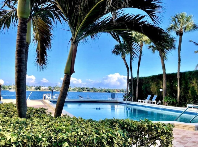 view of pool featuring a water view