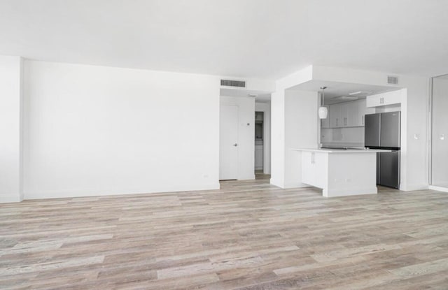 unfurnished living room with light hardwood / wood-style flooring