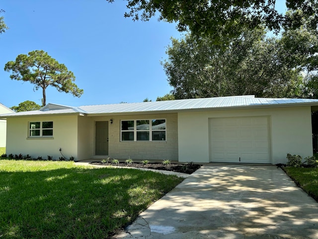 ranch-style house featuring a garage and a front yard