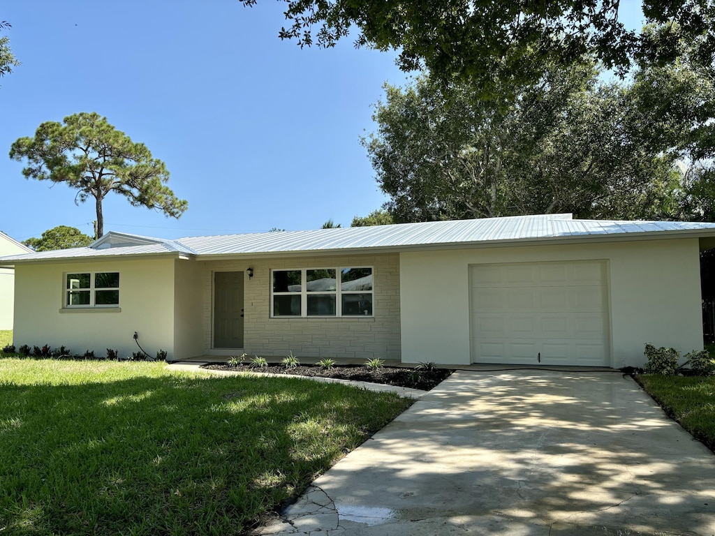 ranch-style house with a front yard and a garage