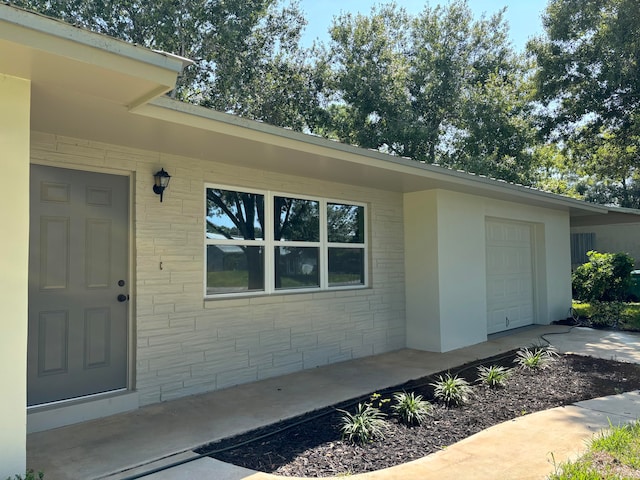 doorway to property with a garage