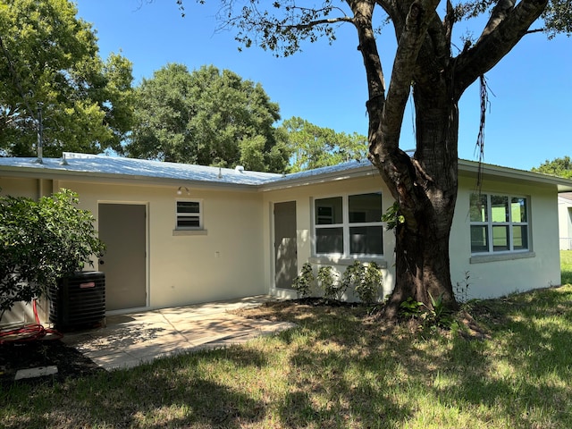 back of property with a patio area and cooling unit