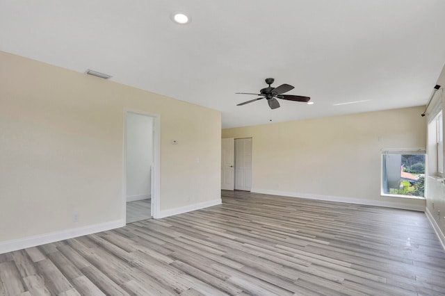 empty room featuring ceiling fan and light hardwood / wood-style flooring