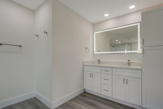 bathroom featuring vanity, a shower with shower door, and hardwood / wood-style floors