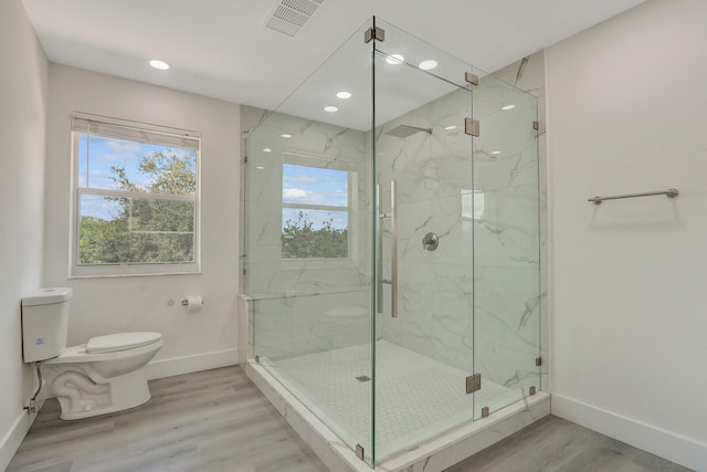 bathroom with walk in shower, wood-type flooring, and toilet