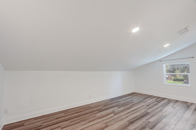 bonus room featuring lofted ceiling and light hardwood / wood-style floors