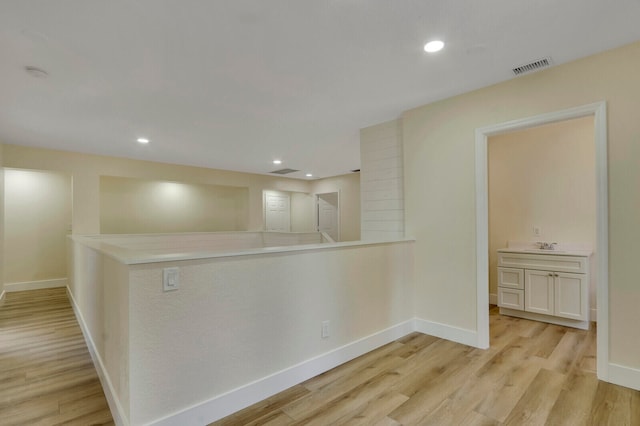 empty room featuring light hardwood / wood-style flooring and sink