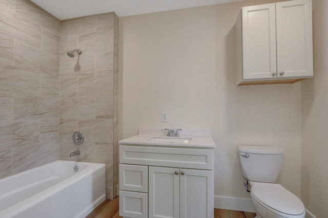 full bathroom featuring wood-type flooring, vanity, toilet, and tiled shower / bath combo