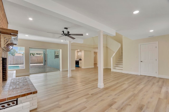 unfurnished living room featuring ceiling fan and light hardwood / wood-style floors