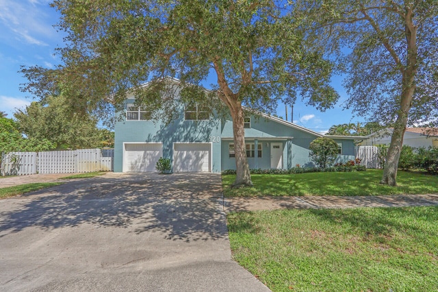 view of front of home with a garage and a front lawn