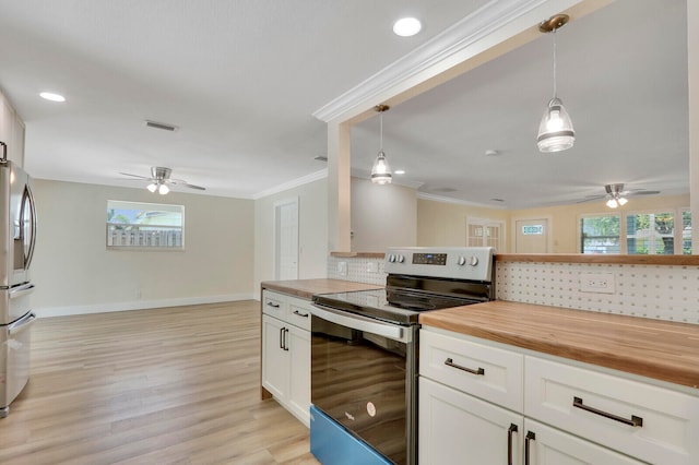 kitchen with decorative light fixtures, stainless steel appliances, white cabinets, and butcher block countertops