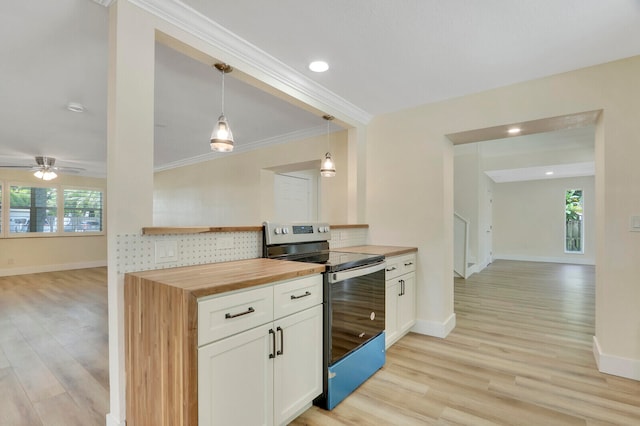 kitchen with white cabinets, decorative light fixtures, light hardwood / wood-style flooring, stainless steel electric stove, and wood counters