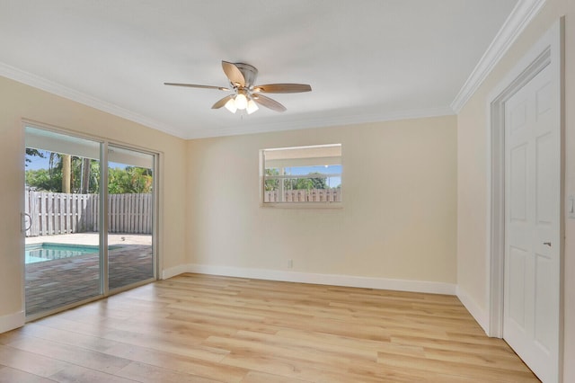 spare room with ceiling fan, light wood-type flooring, plenty of natural light, and crown molding