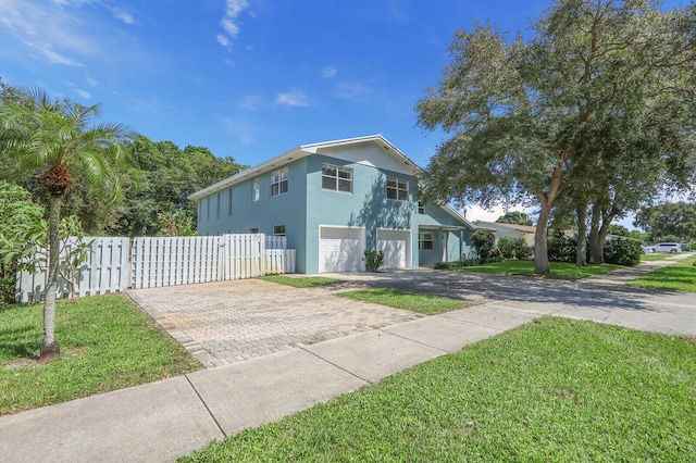 view of side of home featuring a garage and a lawn