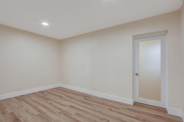 empty room with light hardwood / wood-style flooring