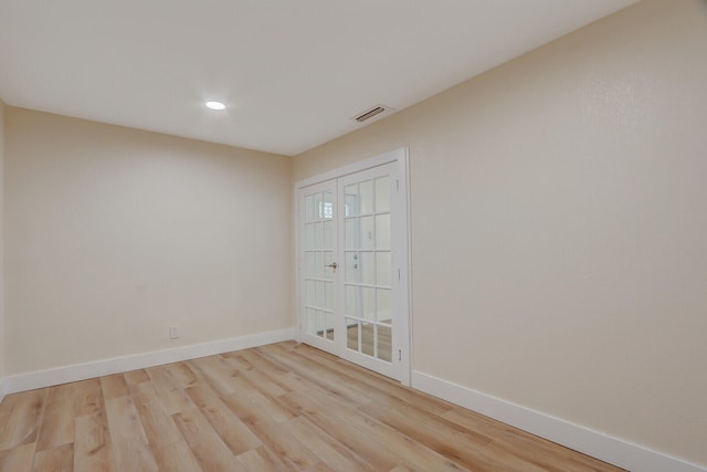 unfurnished room with french doors and light hardwood / wood-style floors