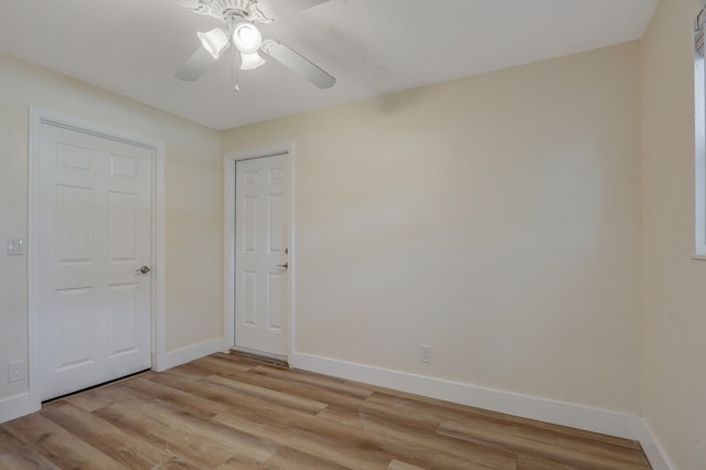 empty room featuring ceiling fan and light hardwood / wood-style flooring