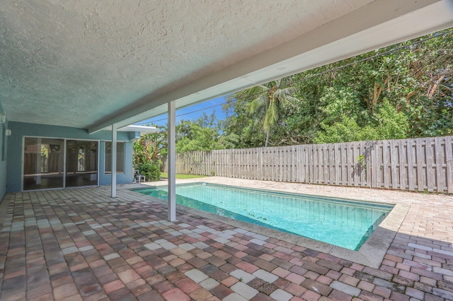 view of swimming pool with a patio area