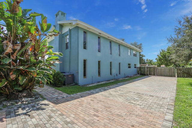 view of property exterior featuring central AC and a patio area