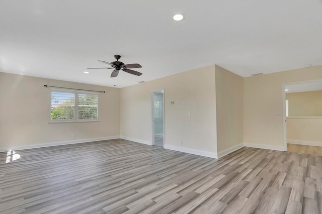 spare room with light wood-type flooring and ceiling fan