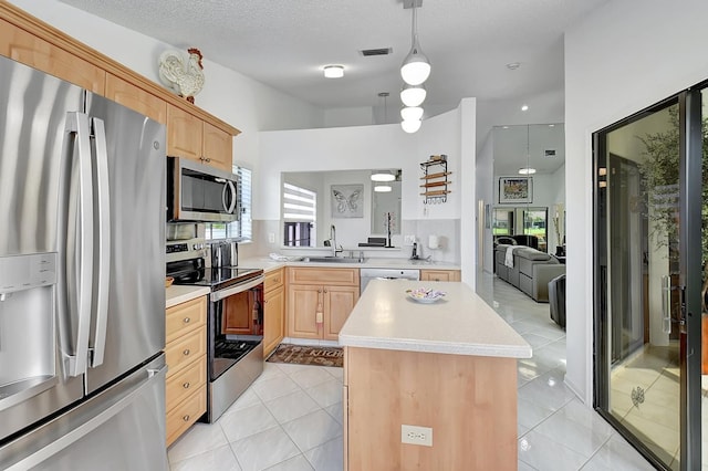 kitchen featuring appliances with stainless steel finishes, light brown cabinetry, light tile patterned flooring, and a kitchen island