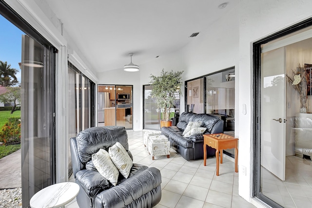 sunroom featuring lofted ceiling and a healthy amount of sunlight