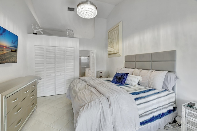 bedroom with an inviting chandelier and light tile patterned floors