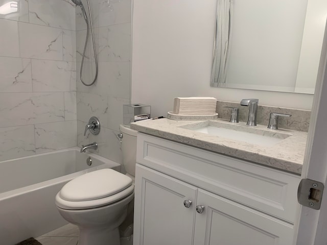 full bathroom with tiled shower / bath, toilet, tile patterned floors, and vanity