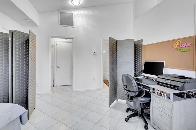 tiled home office with a high ceiling