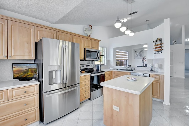 kitchen with a kitchen island, light brown cabinetry, light tile patterned floors, lofted ceiling, and stainless steel appliances