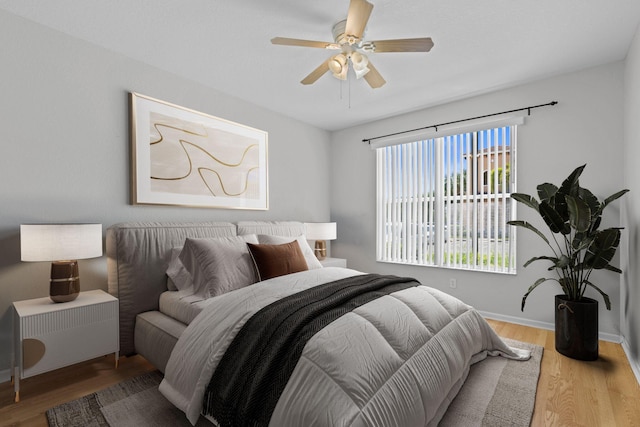 bedroom featuring hardwood / wood-style flooring and ceiling fan