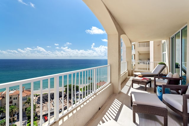 balcony featuring a water view and a view of the beach