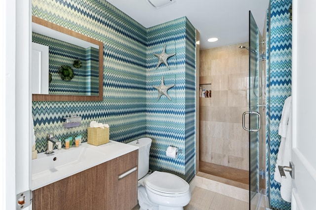 bathroom with vanity, toilet, and an enclosed shower