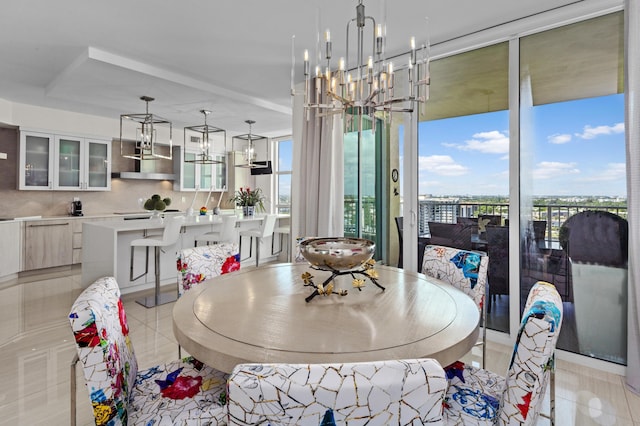 tiled dining room with an inviting chandelier