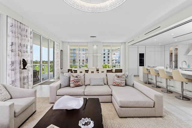 living room featuring an inviting chandelier and sink