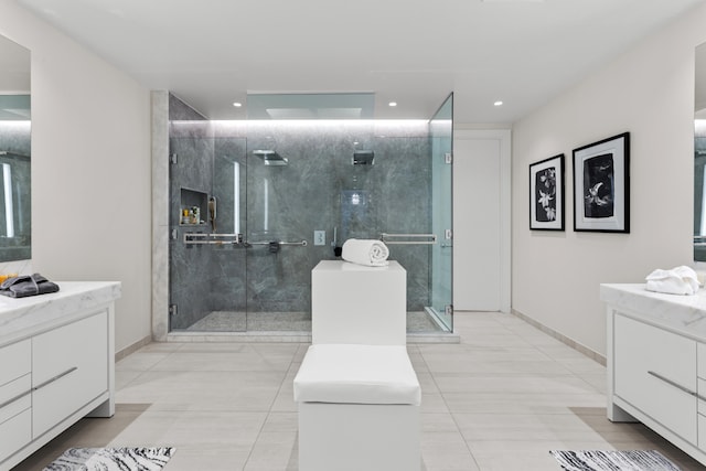 bathroom with tile patterned flooring, vanity, and walk in shower